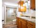 Bathroom featuring a shower, toilet, wooden cabinets, and decorative shower door at 4830 Melody Ln, Lakeland, FL 33805
