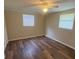 Bedroom featuring new flooring and lots of natural light from two windows at 4830 Melody Ln, Lakeland, FL 33805