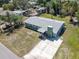 Aerial view of a charming one-story home with a well-maintained yard and a long concrete driveway at 4830 Melody Ln, Lakeland, FL 33805
