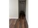 A freshly painted hallway featuring new flooring and clean lines that leads to various rooms at 4830 Melody Ln, Lakeland, FL 33805
