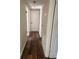 A well-lit hallway featuring fresh paint and new flooring, connecting different areas of the home at 4830 Melody Ln, Lakeland, FL 33805