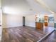 Open concept living room with warm wood floors flowing into the kitchen at 4830 Melody Ln, Lakeland, FL 33805