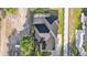 Home featuring a screened pool, three-car garage, large driveway, and new landscaping at 5087 Cliffside Drive, Lakeland, FL 33813