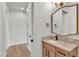 Bathroom vanity with a light-toned countertop, sleek faucet, drawers, and a decorative gold trimmed mirror at 5087 Cliffside Drive, Lakeland, FL 33813