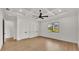 Well-lit bedroom showcasing tray ceilings, wood floors, and double-door closet at 5087 Cliffside Drive, Lakeland, FL 33813