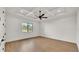 Bright bedroom with tray ceiling, fan, hardwood floors, and large window at 5087 Cliffside Drive, Lakeland, FL 33813