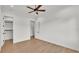 Spacious bedroom with ceiling fan, wood floors, and two entryways: one to a closet, and one to another room at 5087 Cliffside Drive, Lakeland, FL 33813