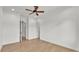 Spacious bedroom featuring hardwood floors, ceiling fan, and multiple doorways at 5087 Cliffside Drive, Lakeland, FL 33813