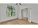 Bright bedroom with natural light featuring hardwood floors, a window, and glass French doors at 5087 Cliffside Drive, Lakeland, FL 33813
