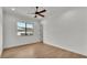Bedroom featuring a ceiling fan, hardwood flooring, a large window, and a view of the exterior of the home at 5087 Cliffside Drive, Lakeland, FL 33813