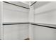 Walk-in closet featuring custom shelving and hanging rods for clothing and accessories storage at 5087 Cliffside Drive, Lakeland, FL 33813