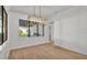 Bright dining area with modern lighting fixture and views of outdoor kitchen at 5087 Cliffside Drive, Lakeland, FL 33813