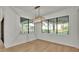 Bright dining area featuring modern light fixture and large windows at 5087 Cliffside Drive, Lakeland, FL 33813