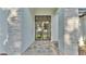 Elegant home entryway boasts stone accents, a tiled walkway, and a modern iron door at 5087 Cliffside Drive, Lakeland, FL 33813