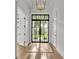 Bright foyer with striking black-framed glass doors and contemporary lighting for an inviting entrance at 5087 Cliffside Drive, Lakeland, FL 33813