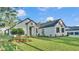 Expansive front yard and exterior view highlight the home's contemporary architectural design at 5087 Cliffside Drive, Lakeland, FL 33813