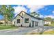 Side view showcasing the three-car garage and the home's stylish stone and neutral color palette at 5087 Cliffside Drive, Lakeland, FL 33813