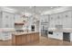 Elegant kitchen with marble countertops, white cabinets, and stainless steel appliances at 5087 Cliffside Drive, Lakeland, FL 33813