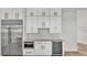 Kitchen featuring stainless steel appliances, wine cooler, and white cabinetry at 5087 Cliffside Drive, Lakeland, FL 33813