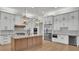 Spacious kitchen featuring white cabinets, a large island with marble countertop, and stainless steel appliances at 5087 Cliffside Drive, Lakeland, FL 33813