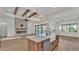 Open-concept kitchen and living area with a fireplace, island, and backyard views at 5087 Cliffside Drive, Lakeland, FL 33813