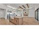 Open-concept kitchen with a large island, farmhouse sink, and stainless steel appliances at 5087 Cliffside Drive, Lakeland, FL 33813
