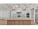 Open kitchen layout featuring a large island with seating and stylish pendant lighting at 5087 Cliffside Drive, Lakeland, FL 33813