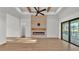 Bright and modern living room with sleek fireplace, accent wall, and sliding glass doors for indoor/outdoor living at 5087 Cliffside Drive, Lakeland, FL 33813