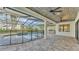 Outdoor pool area with covered patio, kitchen and screened enclosure at 5087 Cliffside Drive, Lakeland, FL 33813