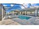 Backyard pool and spa enclosed in a screen with an outdoor kitchen at 5087 Cliffside Drive, Lakeland, FL 33813