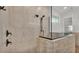 Modern walk-in shower with textured stone, glass surround, and a mounted shower head at 5087 Cliffside Drive, Lakeland, FL 33813
