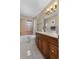 Bathroom features a wood vanity with solid countertops and a tiled shower and tub at 538 Eagle Run, Lakeland, FL 33809