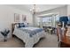 Bright bedroom features a bay window, chandelier, and blue and white bedding at 538 Eagle Run, Lakeland, FL 33809