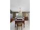 Elegant dining room featuring tile flooring, a chandelier, and a wooden dining set at 538 Eagle Run, Lakeland, FL 33809