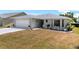 Single-story home with a spacious driveway and quaint outdoor seating area at 538 Eagle Run, Lakeland, FL 33809