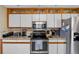 Modern kitchen with stainless steel appliances, granite countertops, and ample cabinet space at 538 Eagle Run, Lakeland, FL 33809