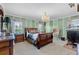 A grand main bedroom features a chandelier and an ensuite bathroom at 538 Eagle Run, Lakeland, FL 33809