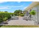Paver patio has outdoor seating and a trimmed hedge for backyard privacy at 538 Eagle Run, Lakeland, FL 33809