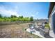 View of the backyard with a white fence, chairs, and green vegetation at 5534 Turkey Creek Way, Lakeland, FL 33811