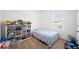 Bright bedroom featuring a bed, window, and a shelf filled with toys on a carpeted floor at 5534 Turkey Creek Way, Lakeland, FL 33811