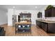 Beautiful kitchen features stainless steel appliances, granite countertops, island, and dark cabinets at 5534 Turkey Creek Way, Lakeland, FL 33811