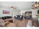 Spacious living room featuring an open-concept design connected to a kitchen with dark cabinetry at 5534 Turkey Creek Way, Lakeland, FL 33811