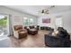 Comfortable living room featuring a ceiling fan, TV, and sliding door at 5534 Turkey Creek Way, Lakeland, FL 33811