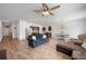 Open-concept living room with ceiling fan flows into dining area and kitchen featuring stainless steel appliances at 5534 Turkey Creek Way, Lakeland, FL 33811