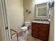 Cozy powder room featuring granite countertop and decorative accents at 564 Meandering Way, Polk City, FL 33868
