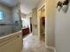 Hallway view of a bathroom with a tiled shower and vanity at 564 Meandering Way, Polk City, FL 33868