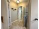 Bathroom showcasing glass enclosed shower, tile flooring, and wall decorations at 564 Meandering Way, Polk City, FL 33868