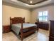 Bedroom features a beautiful wood bed frame, wood nightstands and dresser, and lots of light at 564 Meandering Way, Polk City, FL 33868