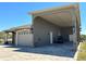 Side exterior showing garage, golf cart, and carport of home under a clear blue sky at 564 Meandering Way, Polk City, FL 33868
