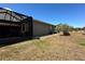 Exterior view of home showcasing lanai and well-maintained yard at 564 Meandering Way, Polk City, FL 33868